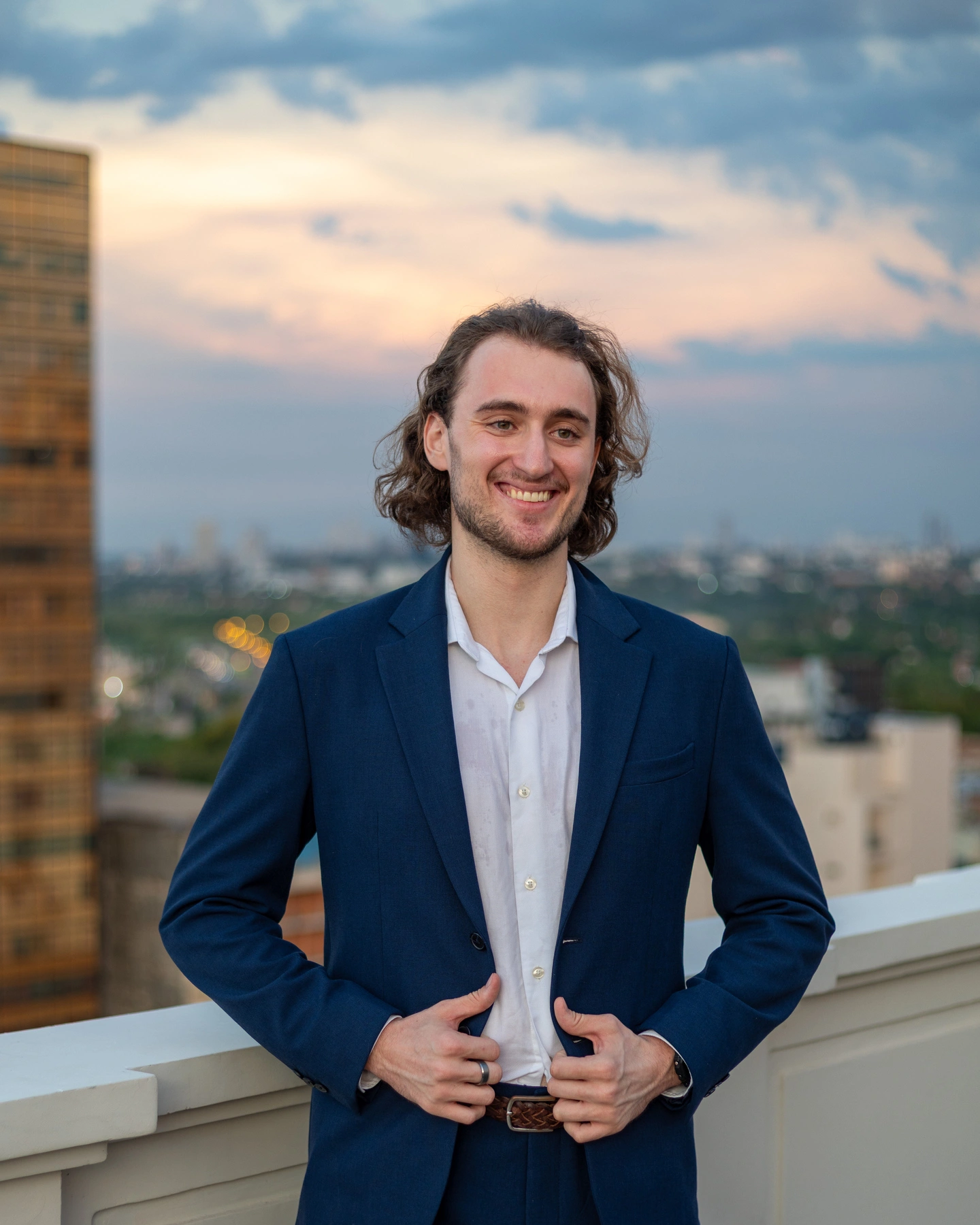 After: Suit on a rooftop at sunset. This became his main.