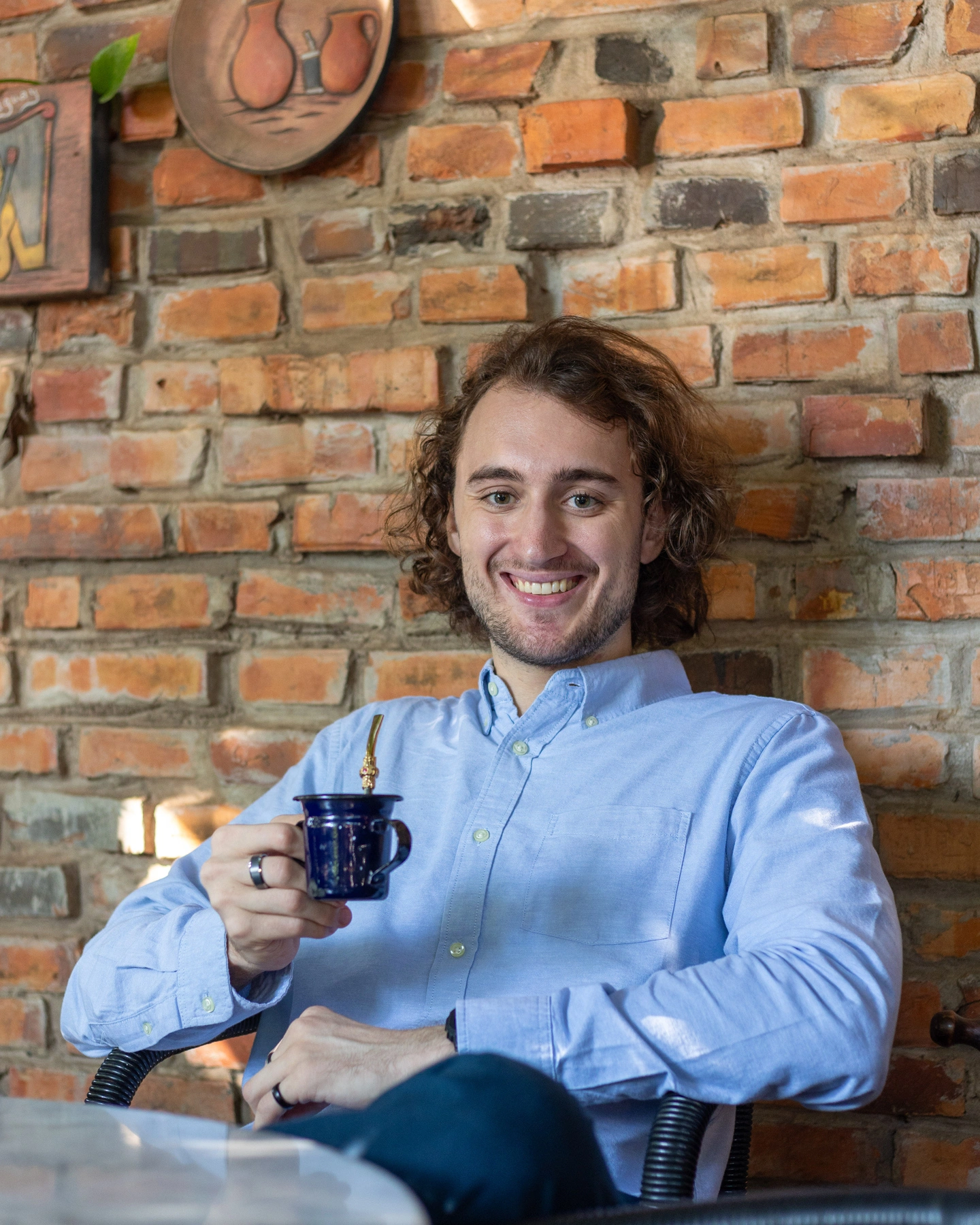 After: Drinking mate at a café. Same energy but it actually works on a profile.
