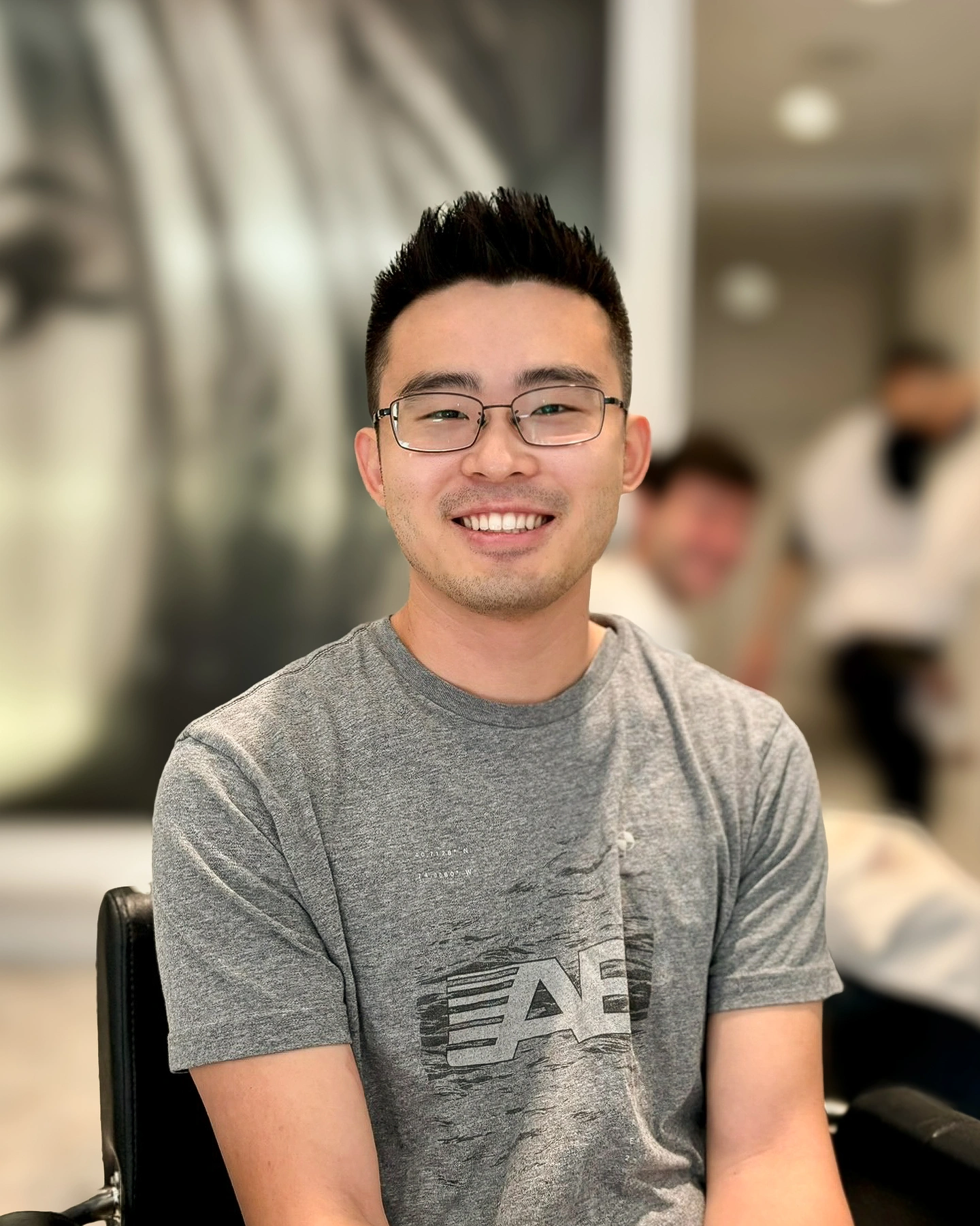 Before: Sitting at the barber in a gym tee. Good smile but it reads like a Yelp review photo.